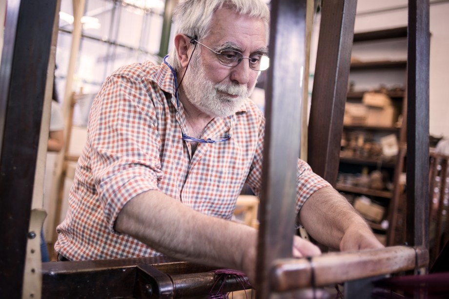 Mature man in his artisanal handicraft traditional textile factory